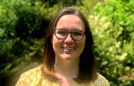 woman with medium long brown hair wearing glasses