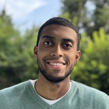 man wearing a v-neck green sweater